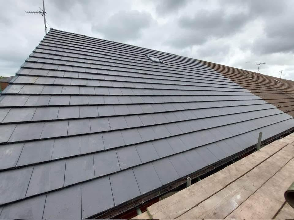 Completed roof with neat rows of dark grey tiles