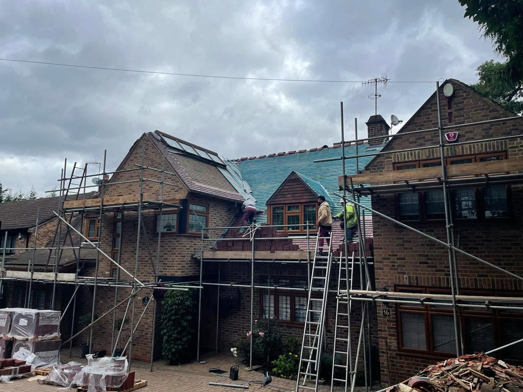 Scaffolding and roof work underway on a brick house in Stockport