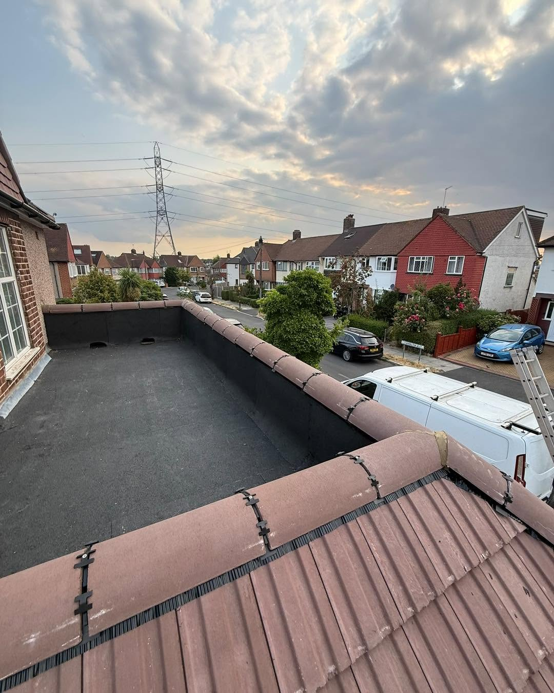 Flat roof behind the tiled edge of a house in Northwich