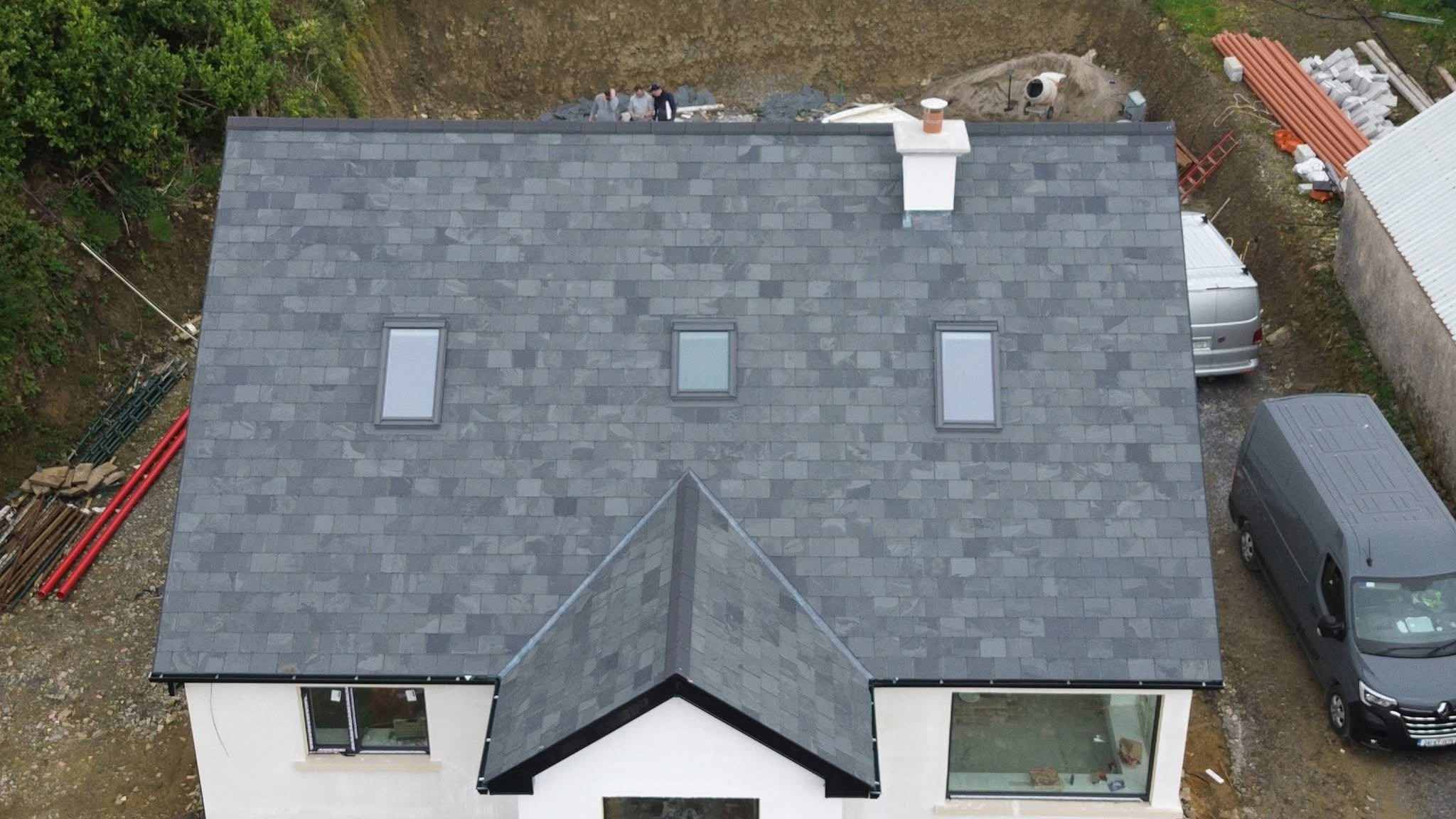 Aerial view of a completed grey roof with three roof windows