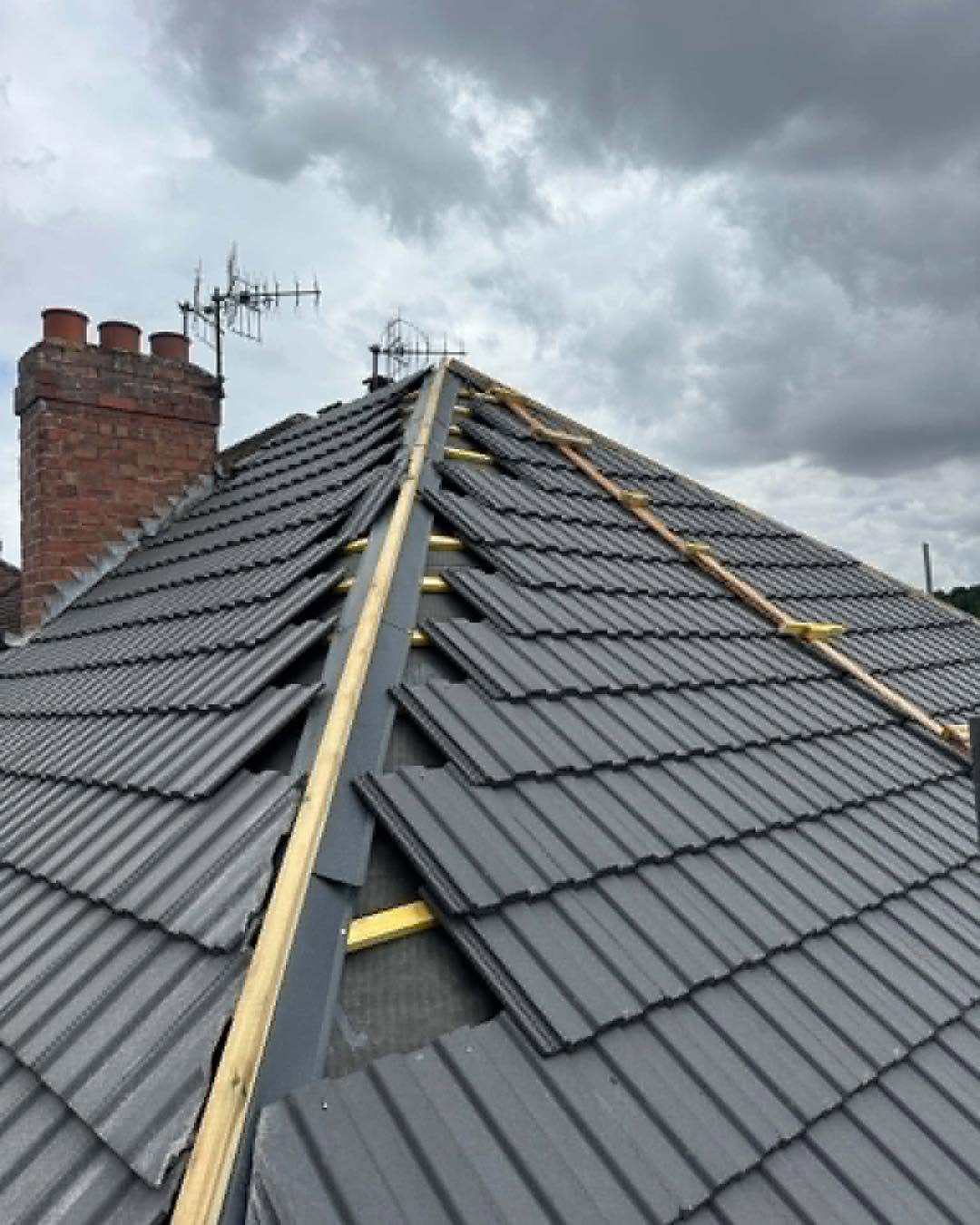 New dark roof tiles, with views of the battens and tiling work